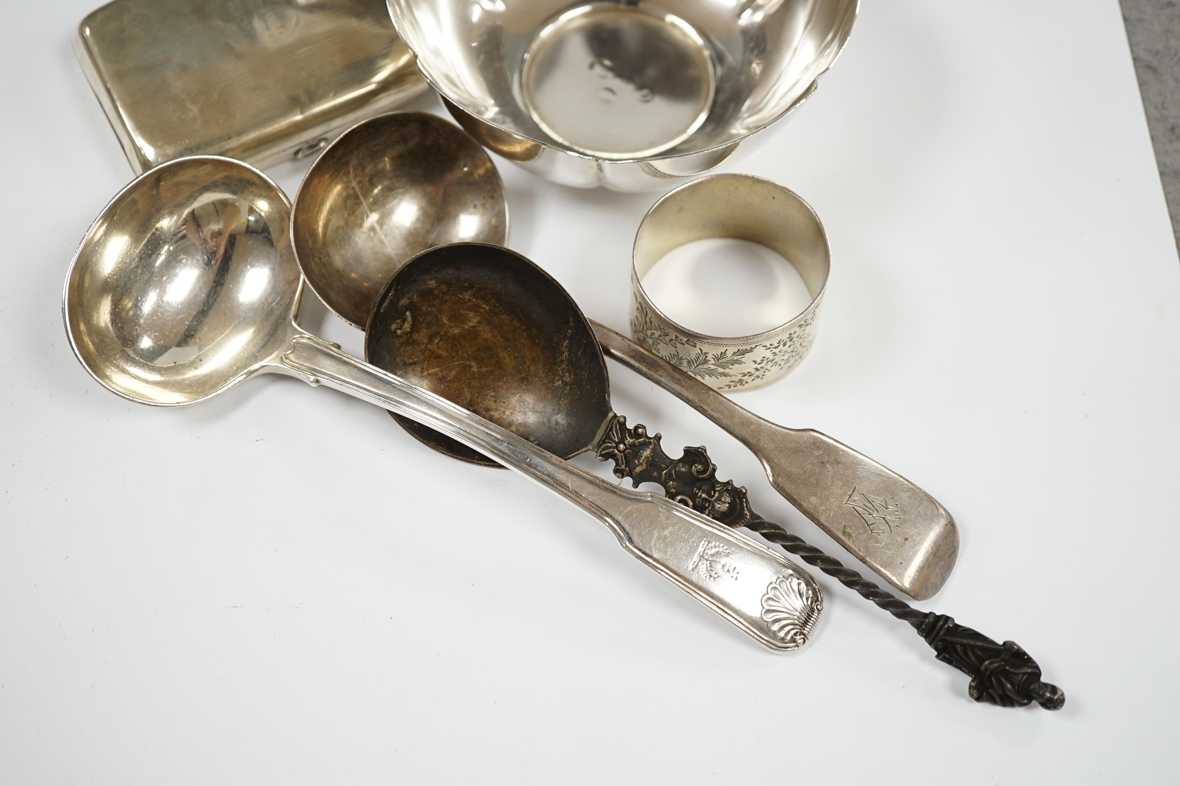 Sundry small silver including a modern bowl by G.J. Dennis, a napkin ring, cigarette case, christening mug and damaged bottle coaster with blue glass liner, together with three items of flatware including a Victorian Iri